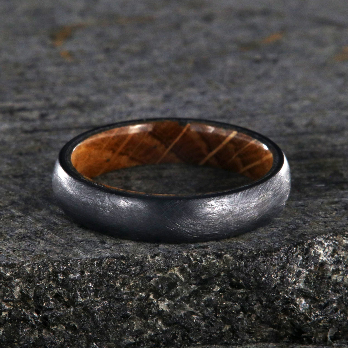 5mm wide black titanium wedding band with a distressed finish, rounded profile, and whiskey barrel sleeve