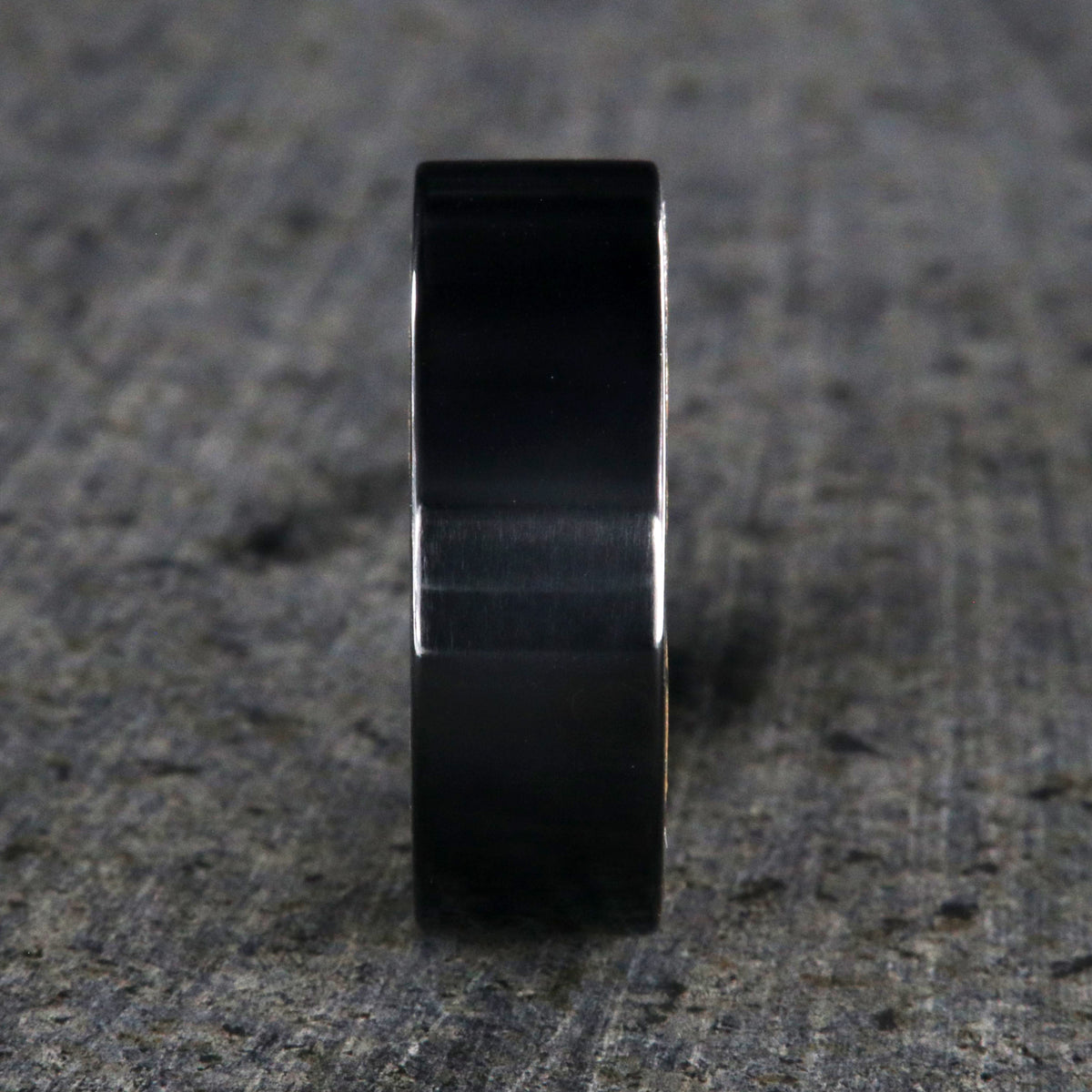 8mm wide black titanium wedding band with a whiskey barrel sleeve and flat profile