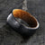 8mm with black titanium wedding band with a tree bark finish and whiskey barrel sleeve