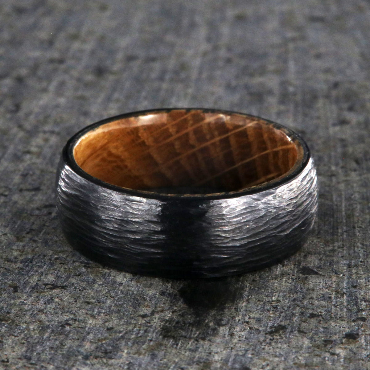 8mm with black titanium wedding band with a tree bark finish and whiskey barrel sleeve