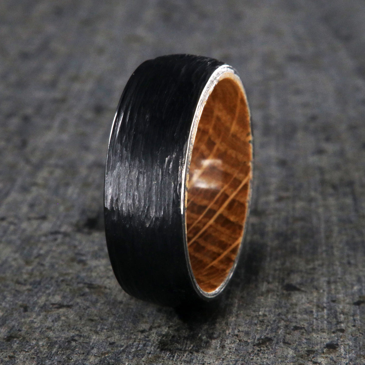 8mm with black titanium wedding band with a tree bark finish and whiskey barrel sleeve