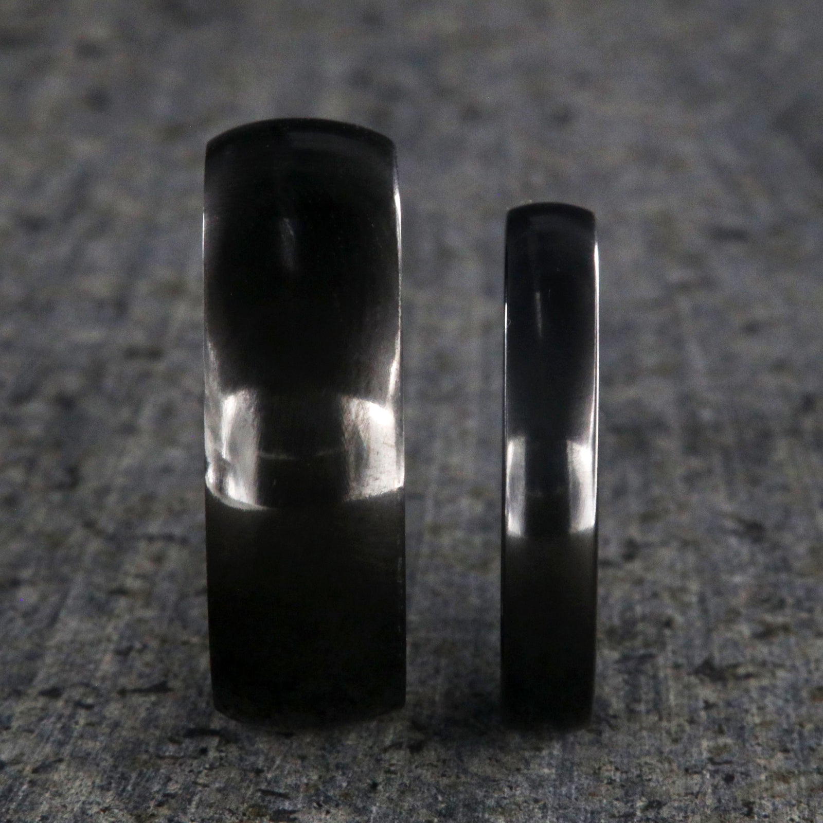 8mm and 4mm wide matching black zirconium wedding ring set with a polished finish and rounded profile