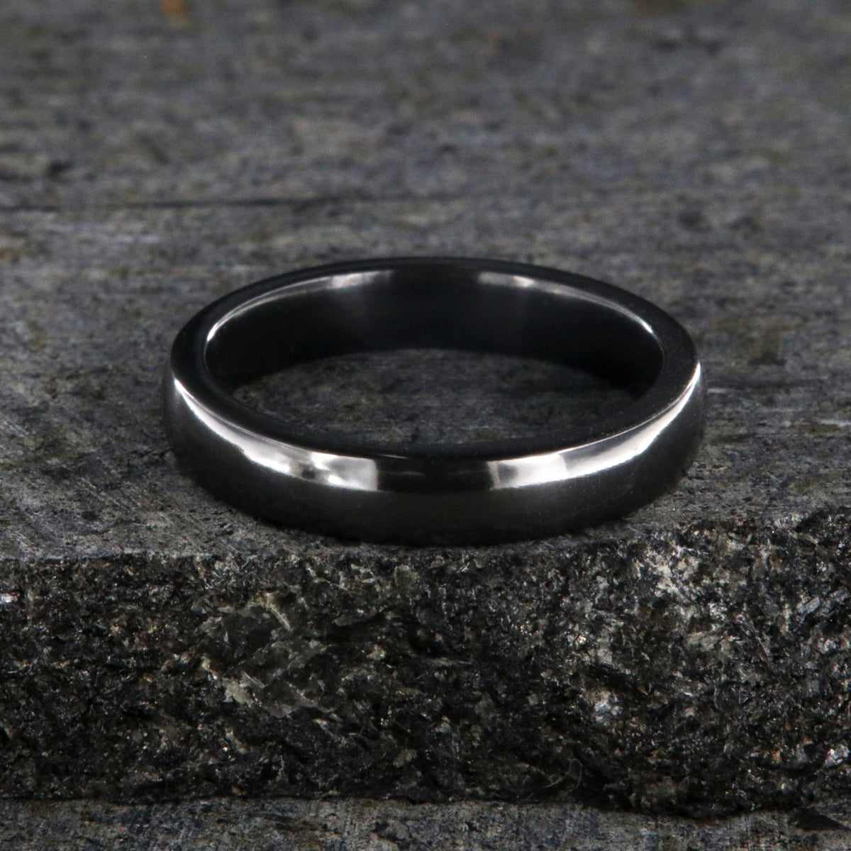 4mm wide black zirconium wedding band with polish finish and rounded profile