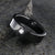 6mm wide black zirconium tension set ring with 3mm round gemstone and diagonal tension