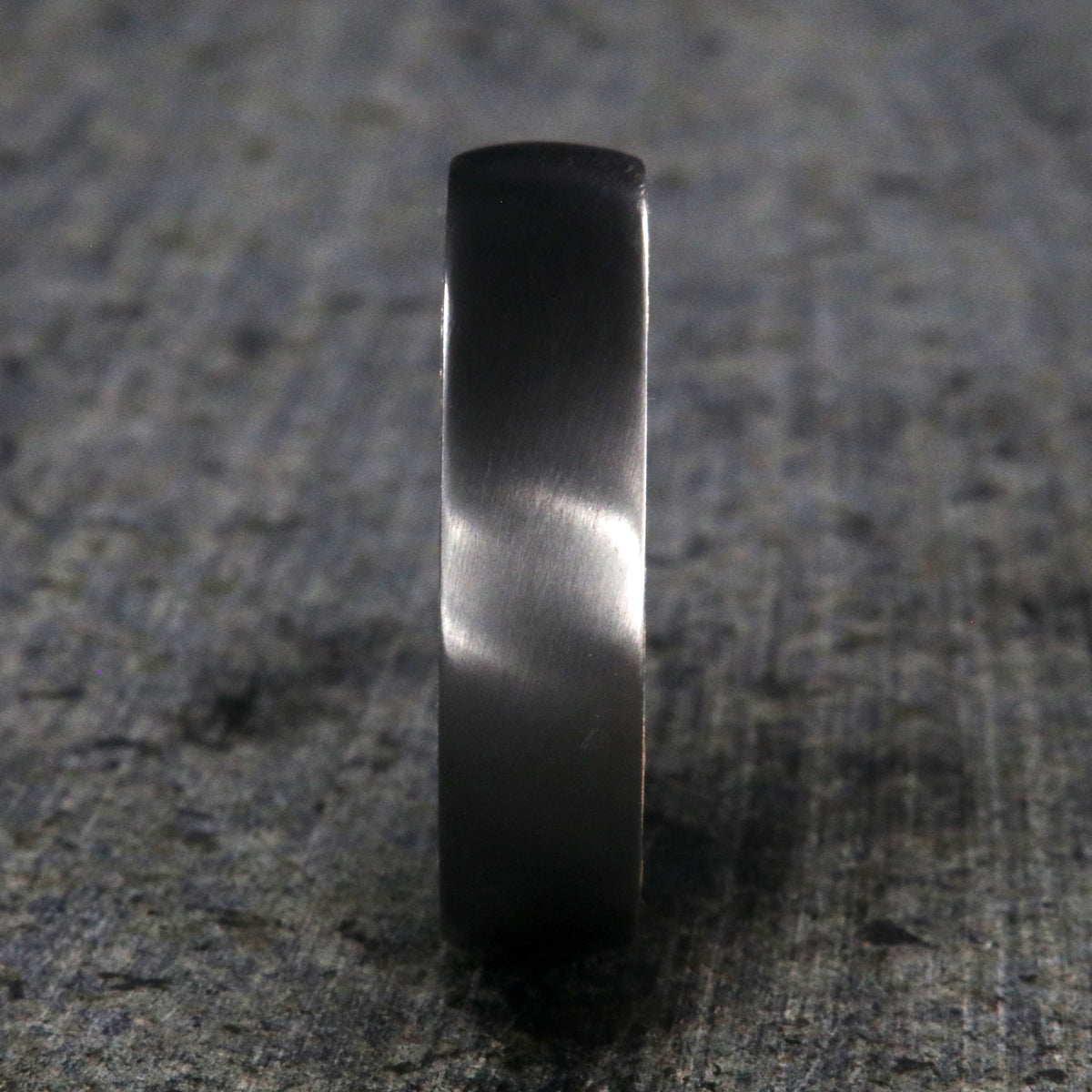 6mm wide black zirconium wedding band with a whiskey barrel sleeve