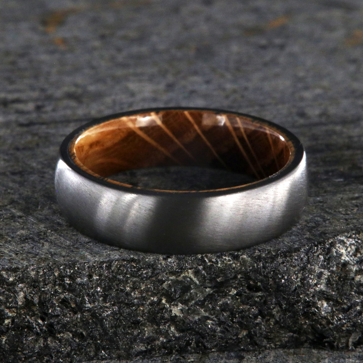 6mm wide black zirconium wedding band with a whiskey barrel sleeve