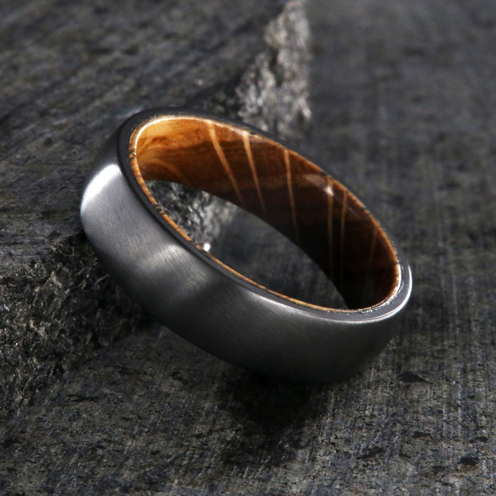 6mm wide black zirconium wedding band with a whiskey barrel sleeve