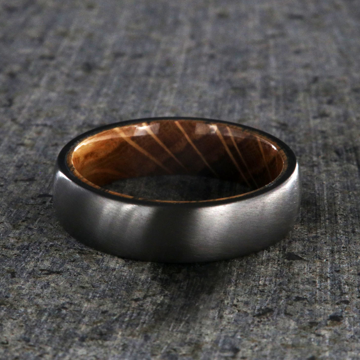 6mm wide black zirconium wedding band with a whiskey barrel sleeve