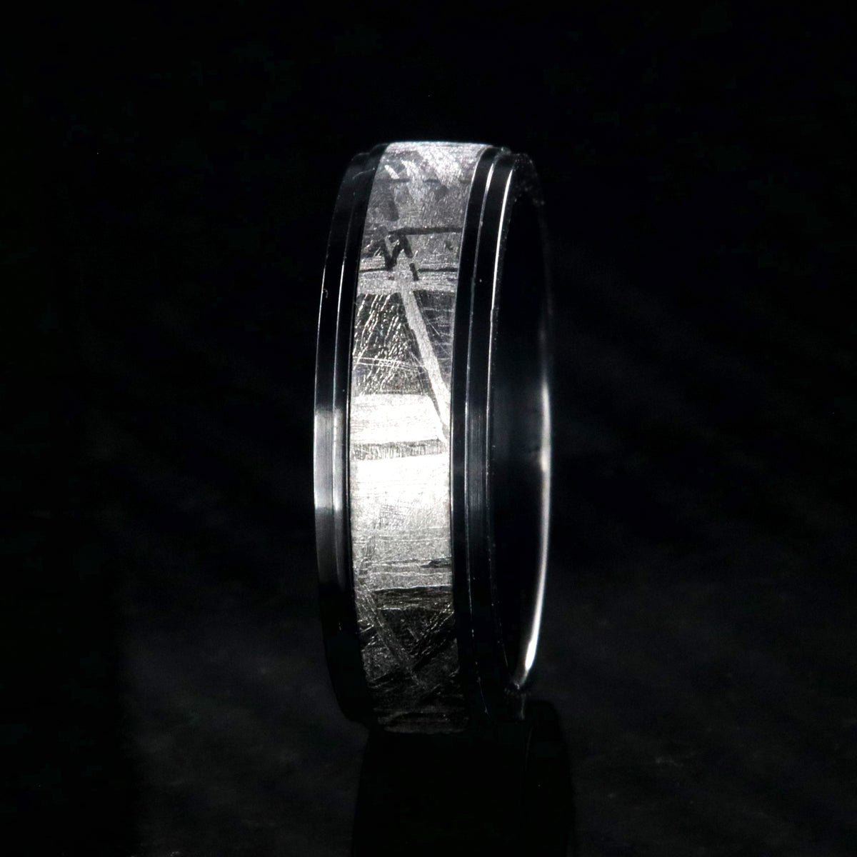 6mm wide men&#39;s meteorite wedding band with a raised center and black zirconium step edges and sleeve
