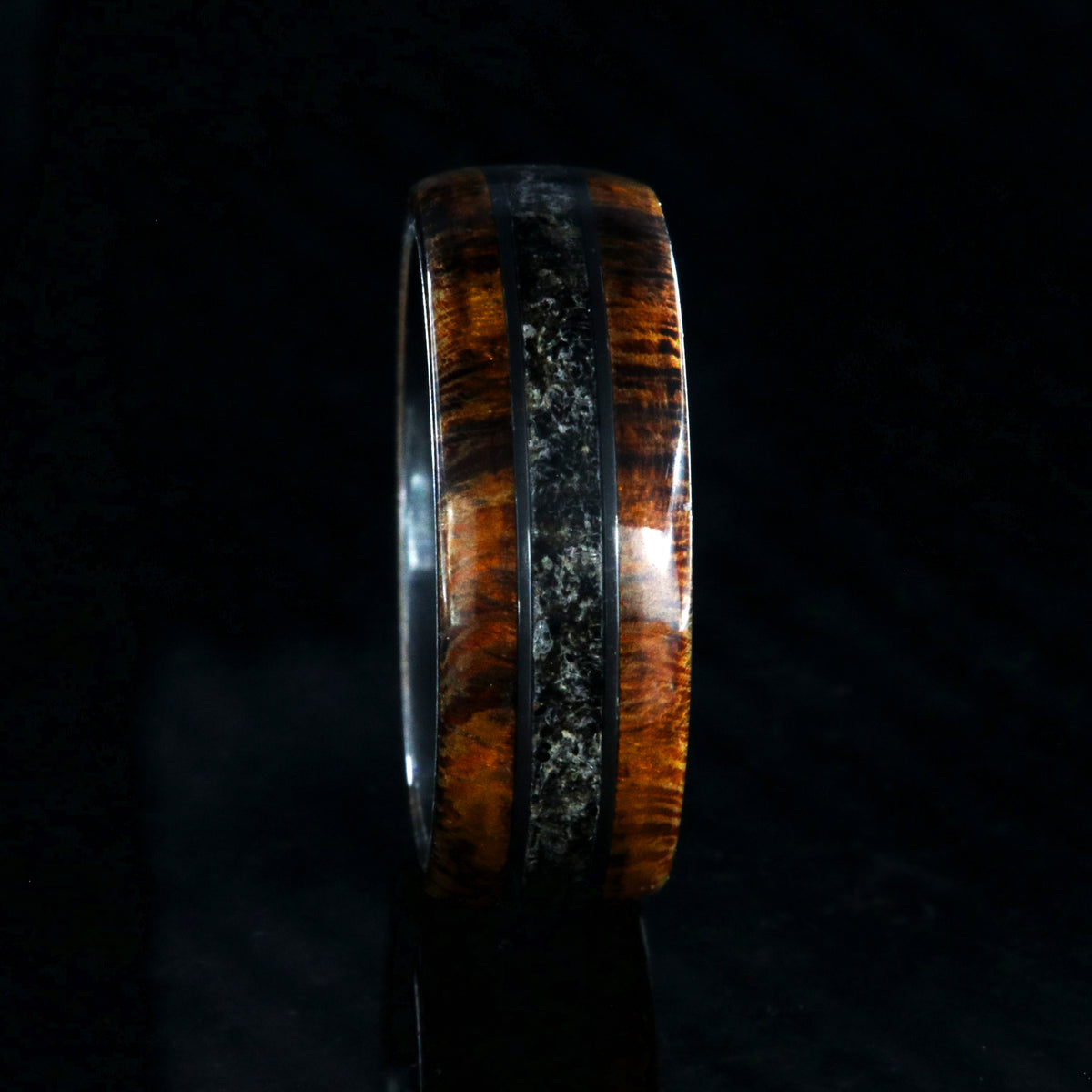7mm wide men&#39;s wedding ring with Arizona ironwood edges and dinosaur bone fossil inlay with a black zirconium sleeve