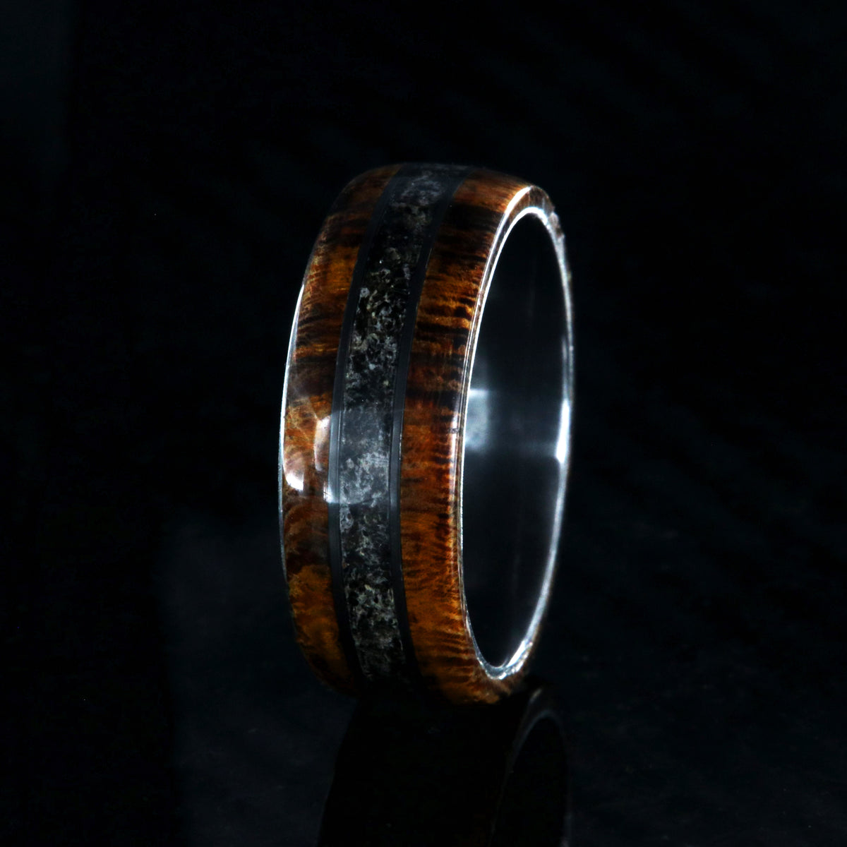 7mm wide men&#39;s wedding ring with Arizona ironwood edges and dinosaur bone fossil inlay with a black zirconium sleeve