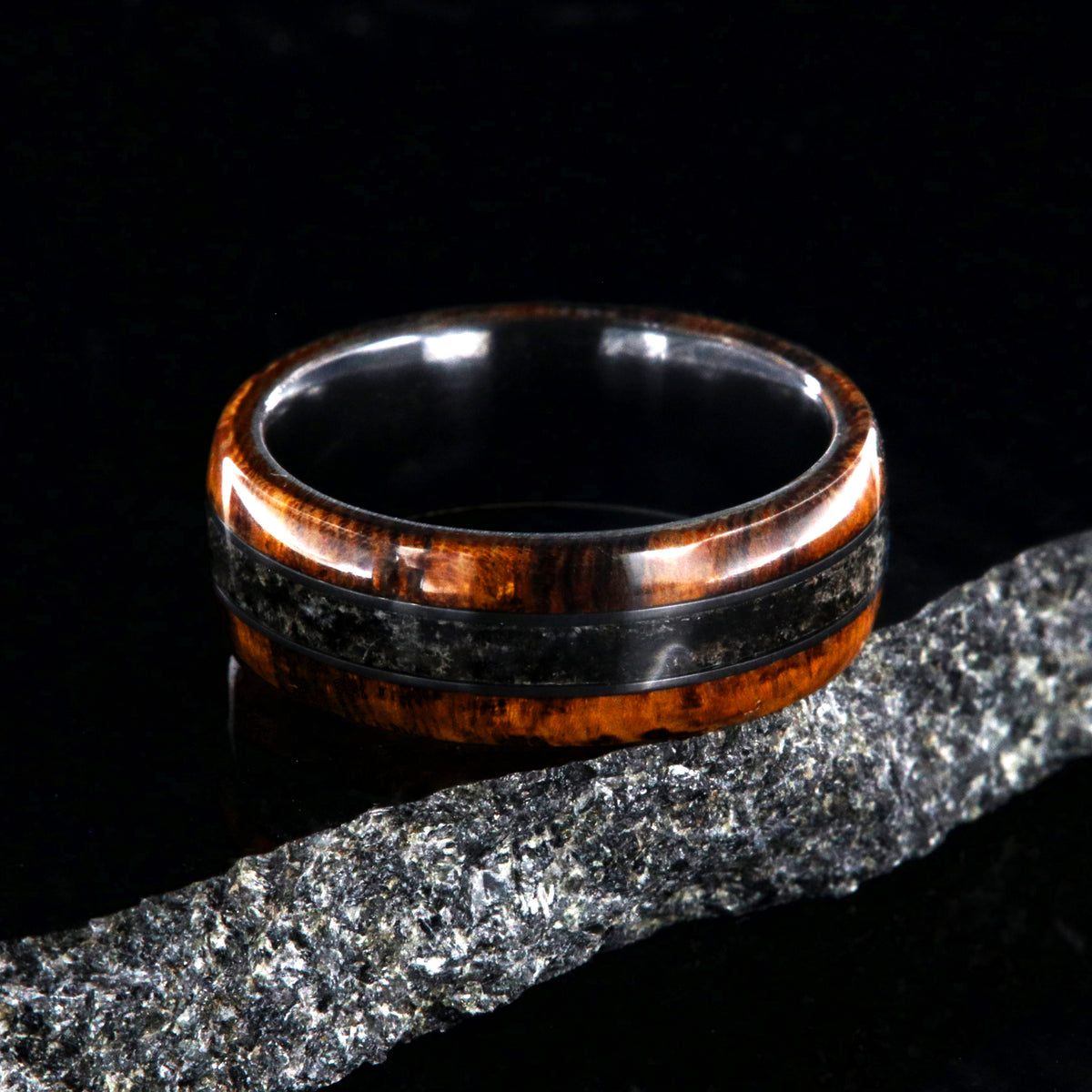 7mm wide men&#39;s wedding ring with Arizona ironwood edges and dinosaur bone fossil inlay with a black zirconium sleeve