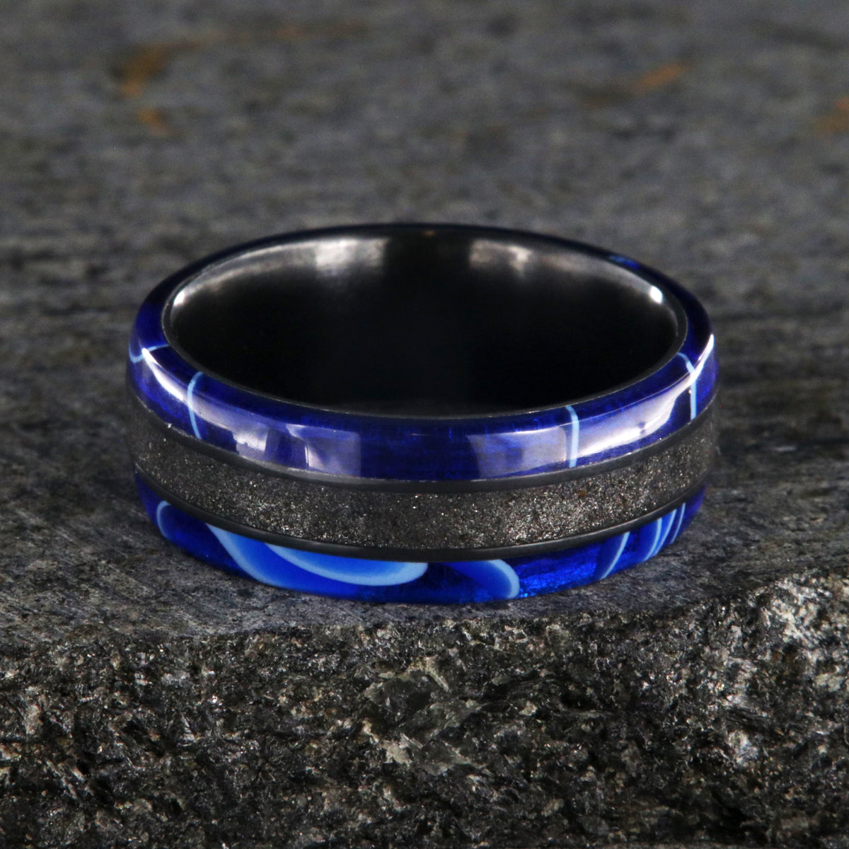 7mm wide swirled blue acrylic ring with black stardust center inlay and black zirconium sleeve