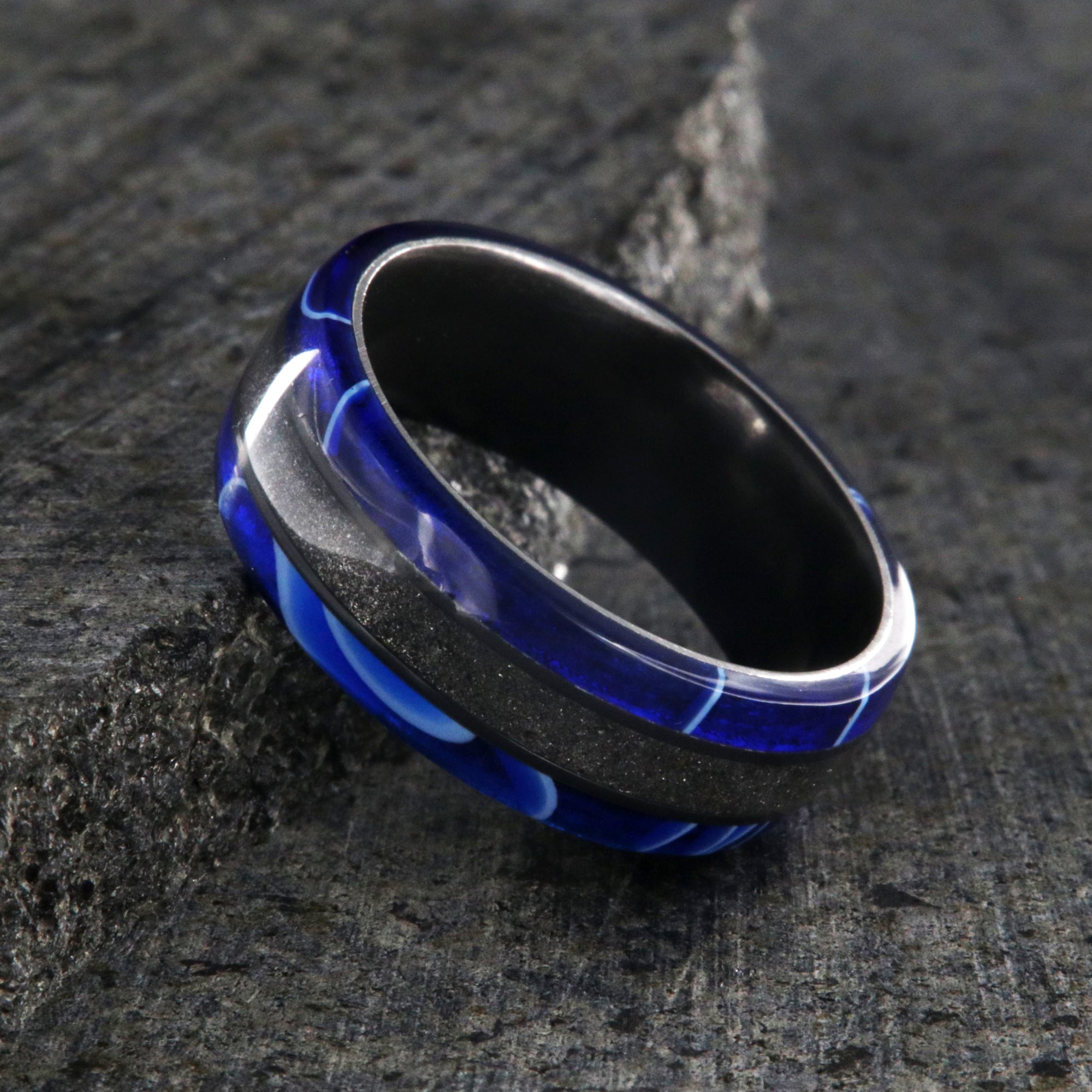 7mm wide swirled blue acrylic ring with black stardust center inlay and black zirconium sleeve