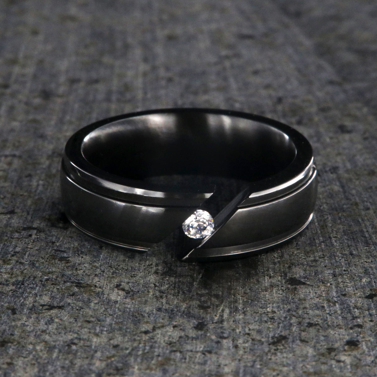 7mm wide black zirconium tension set ring with white sapphire and grooved edges