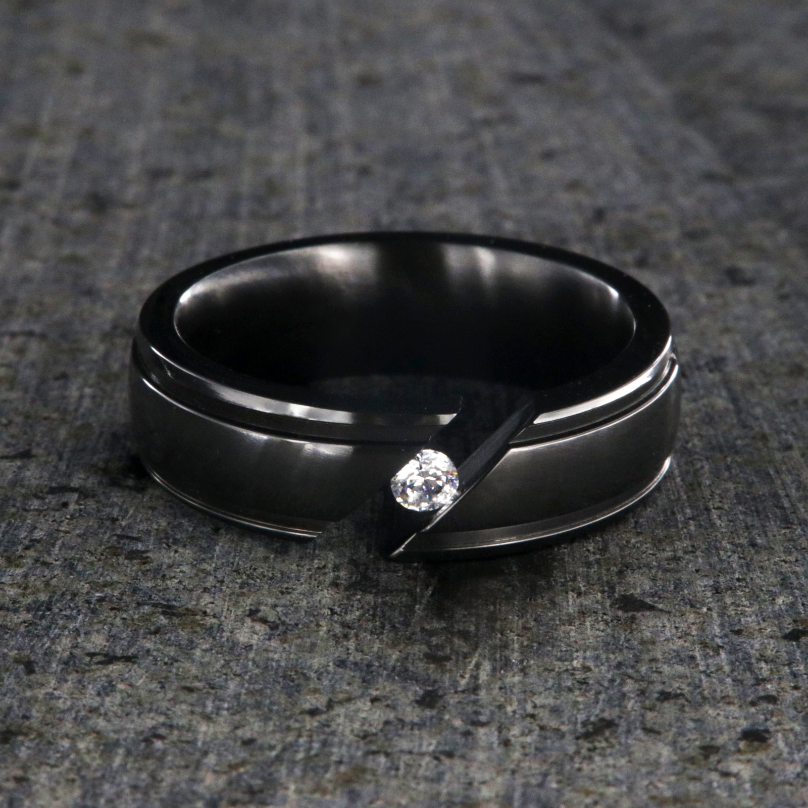 7mm wide black zirconium tension set ring with white sapphire and grooved edges