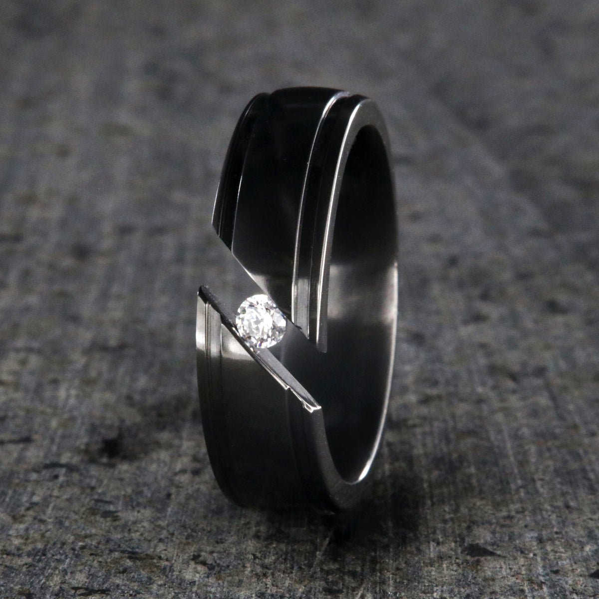 7mm wide black zirconium tension set ring with white sapphire and grooved edges