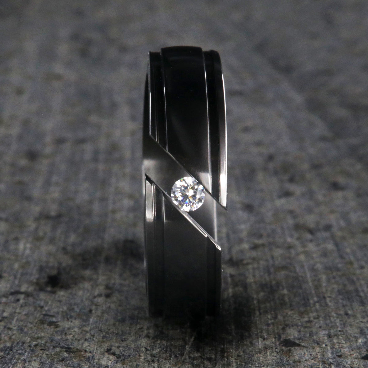 7mm wide black zirconium tension set ring with white sapphire and grooved edges