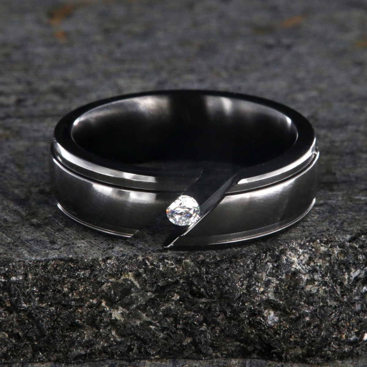 7mm wide black zirconium tension set ring with white sapphire and grooved edges