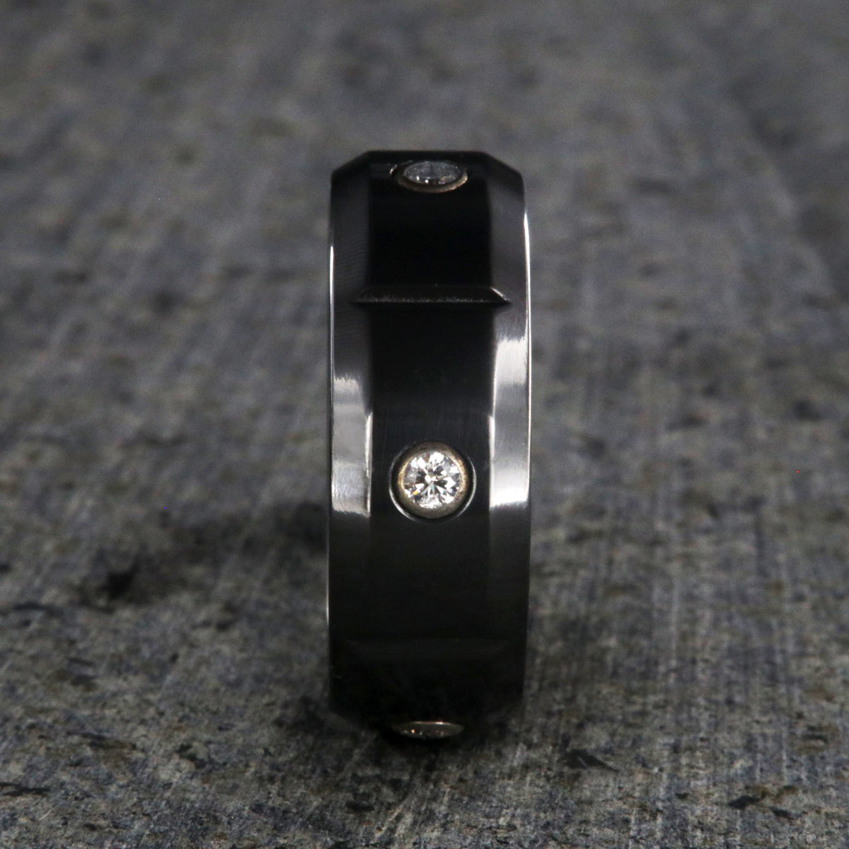 8mm wide black zirconium wedding band with 5 diamonds, beveled edges, and vertical grooves