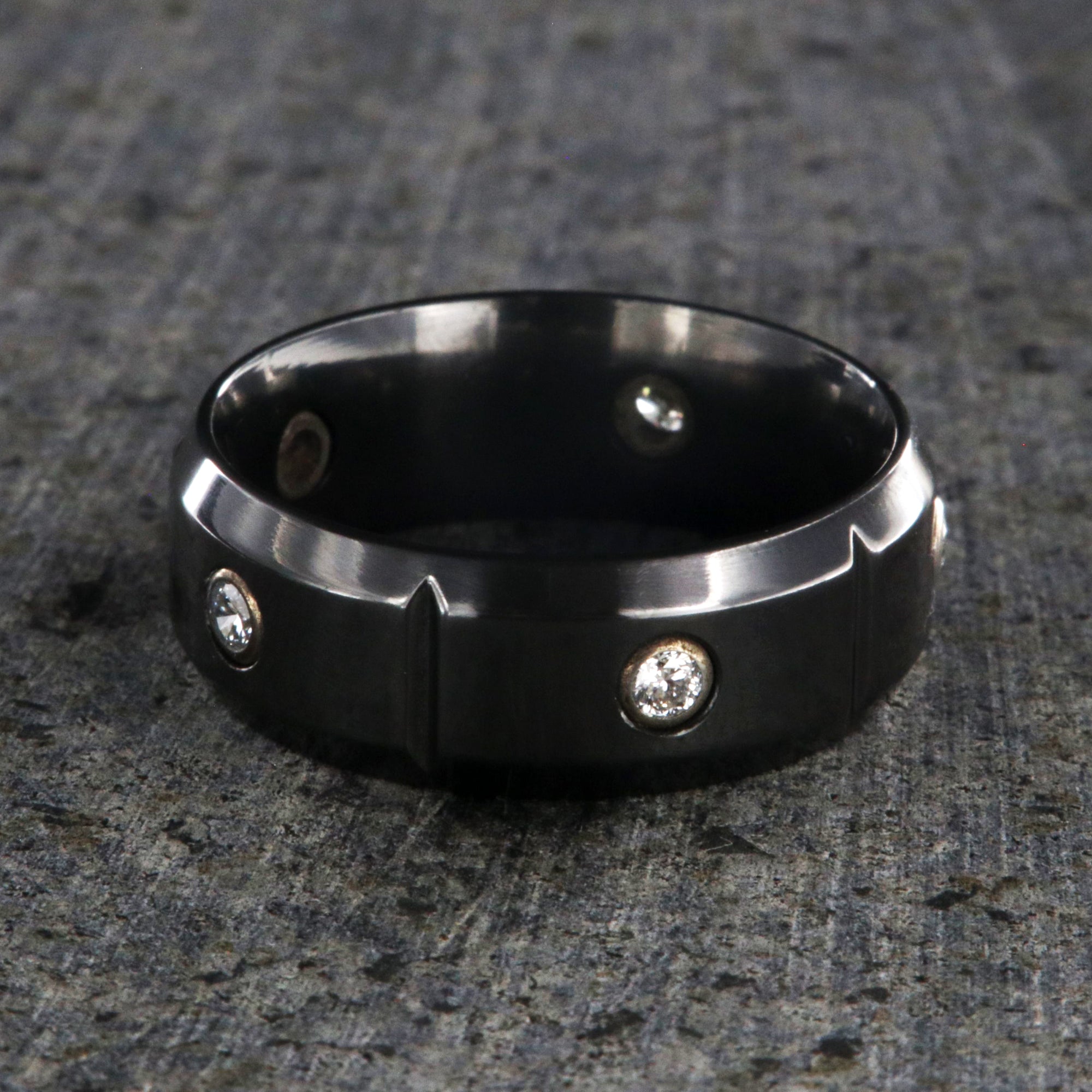 8mm wide black zirconium wedding band with 5 diamonds, beveled edges, and vertical grooves