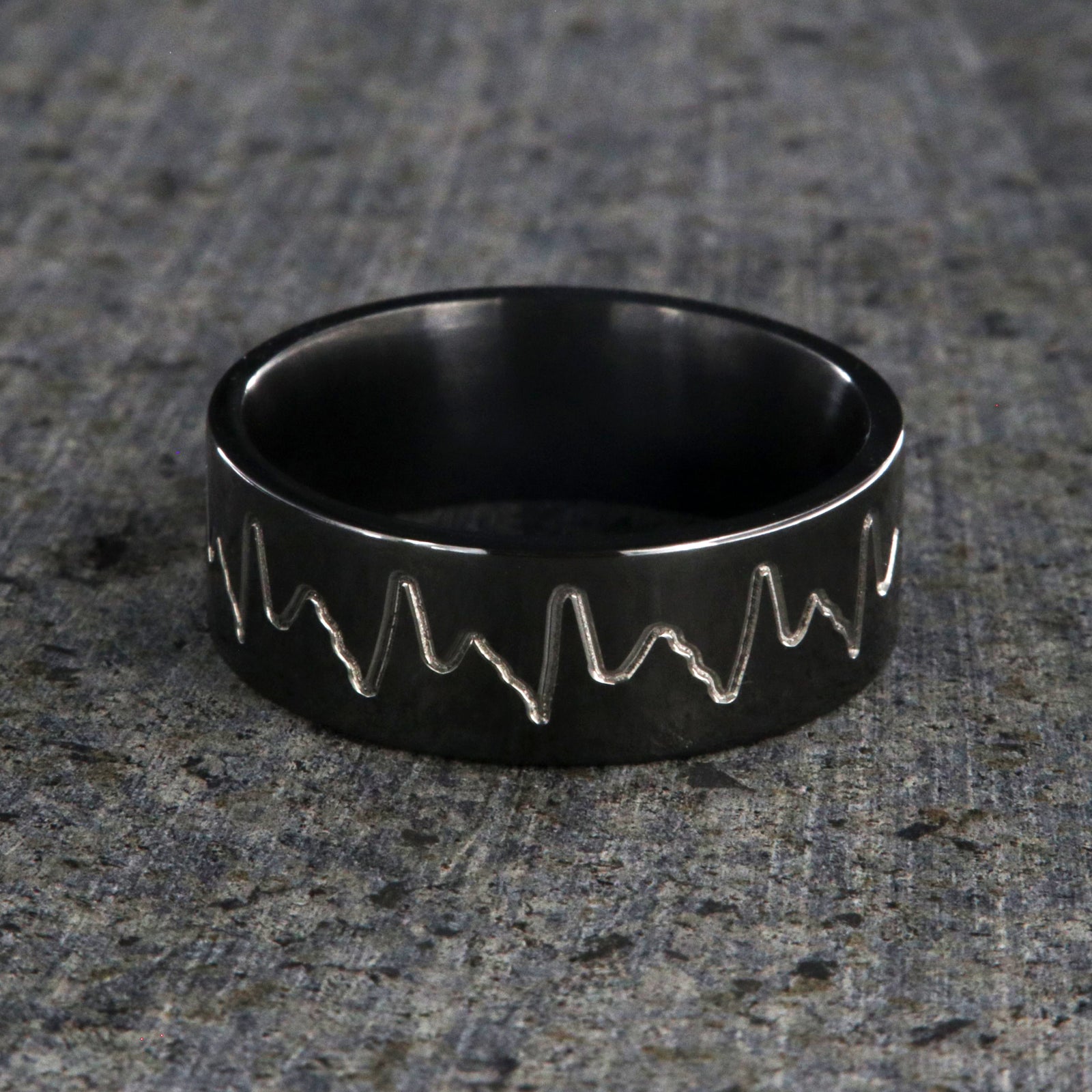 8mm wide black zirconium wedding band with an etched heartbeat design and a flat profile