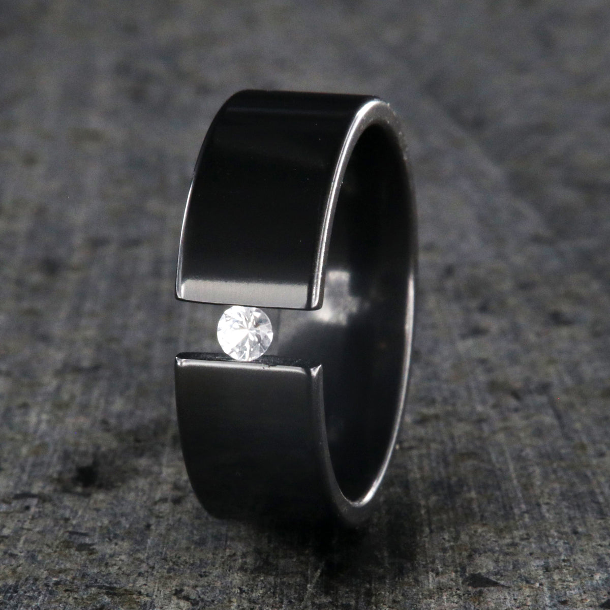 8mm wide black zirconium tension set ring with 3mm round gemstone