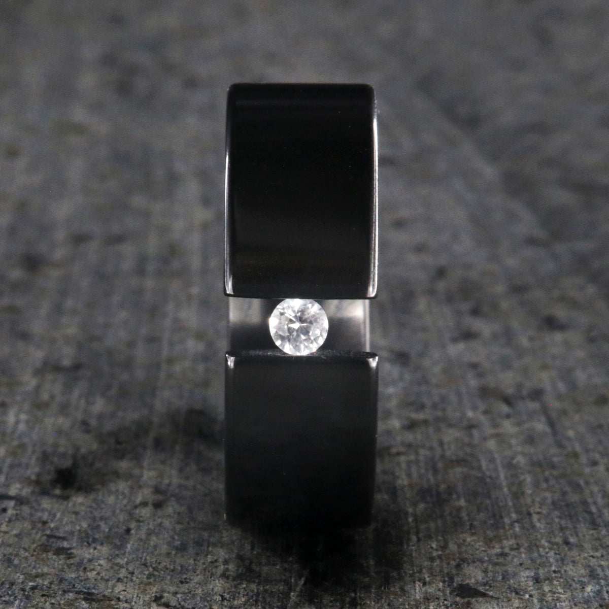 8mm wide black zirconium tension set ring with 3mm round gemstone