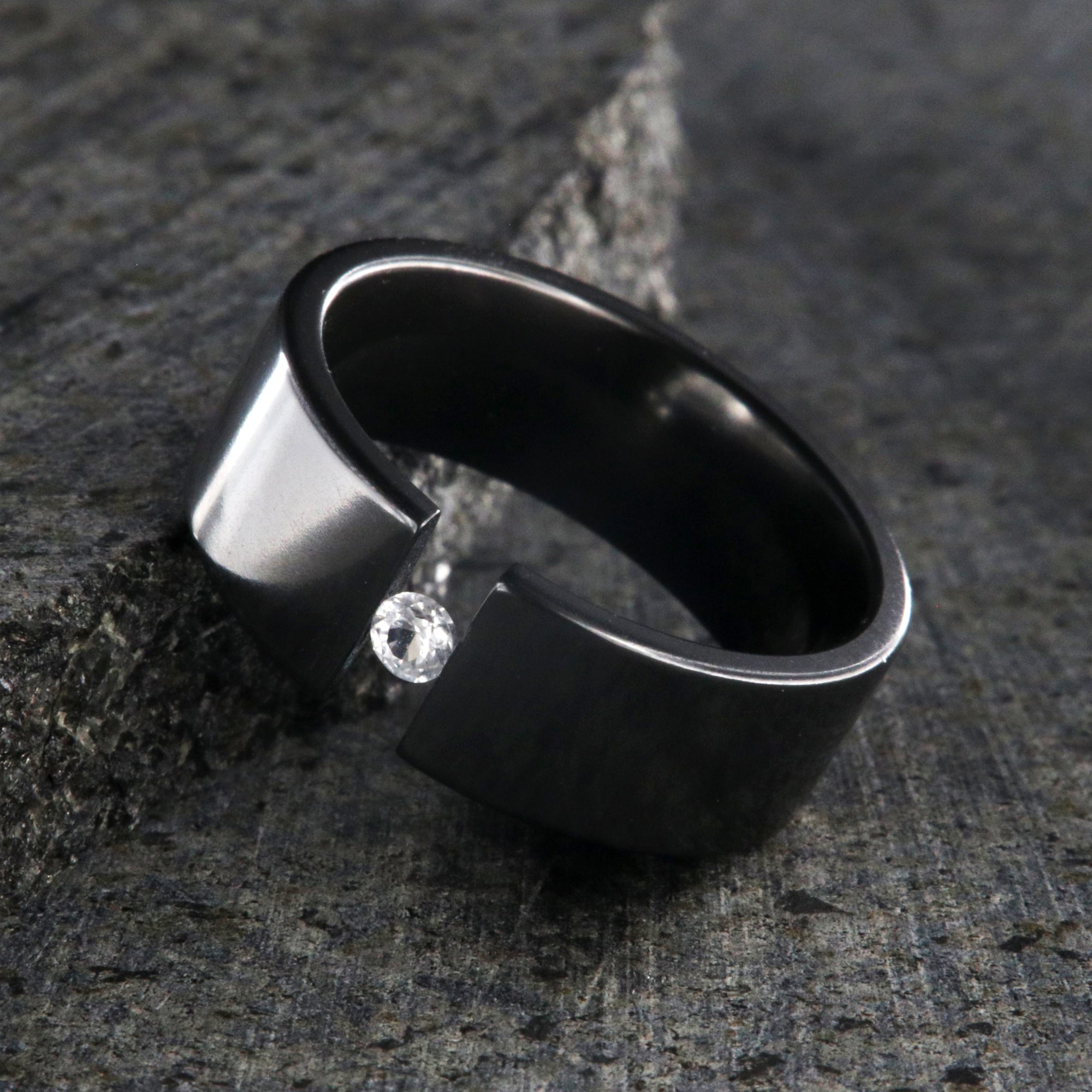 8mm wide black zirconium tension set ring with 3mm round gemstone