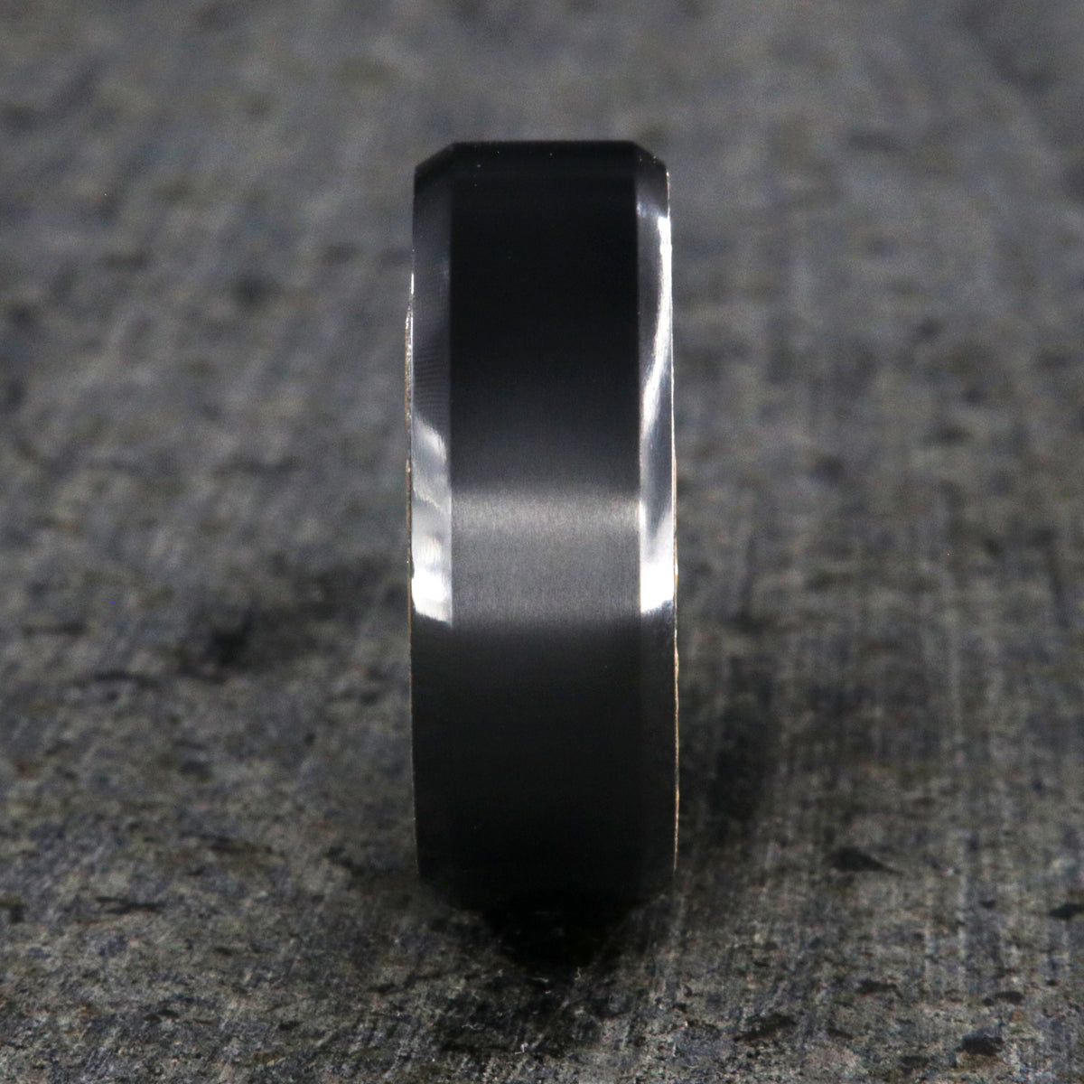8mm wide black zirconium wedding band with beveled edges and a whiskey barrel sleeve