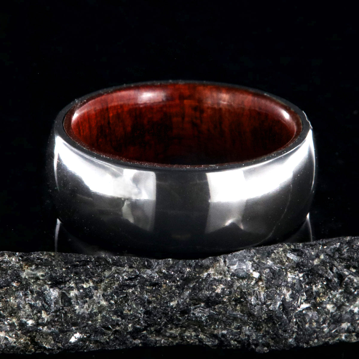 8mm wide black zirconium ring with a polish finish and bloodwood sleeve