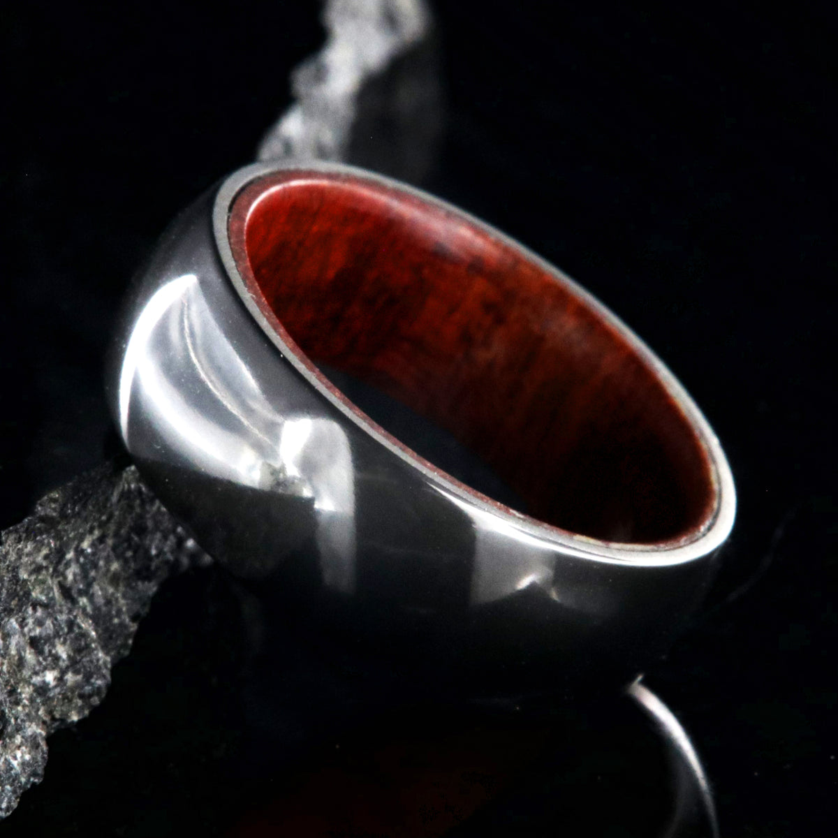 8mm wide black zirconium ring with a polish finish and bloodwood sleeve