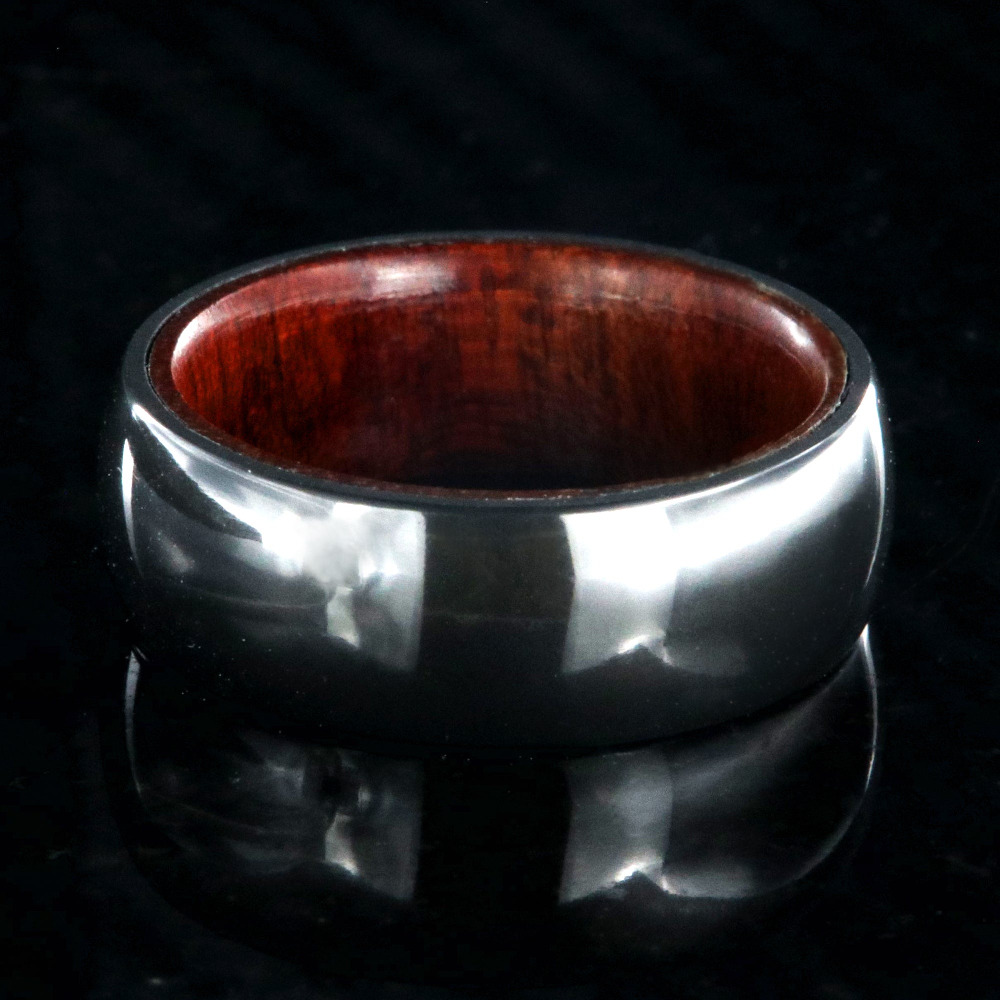 8mm wide black zirconium ring with a polish finish and bloodwood sleeve