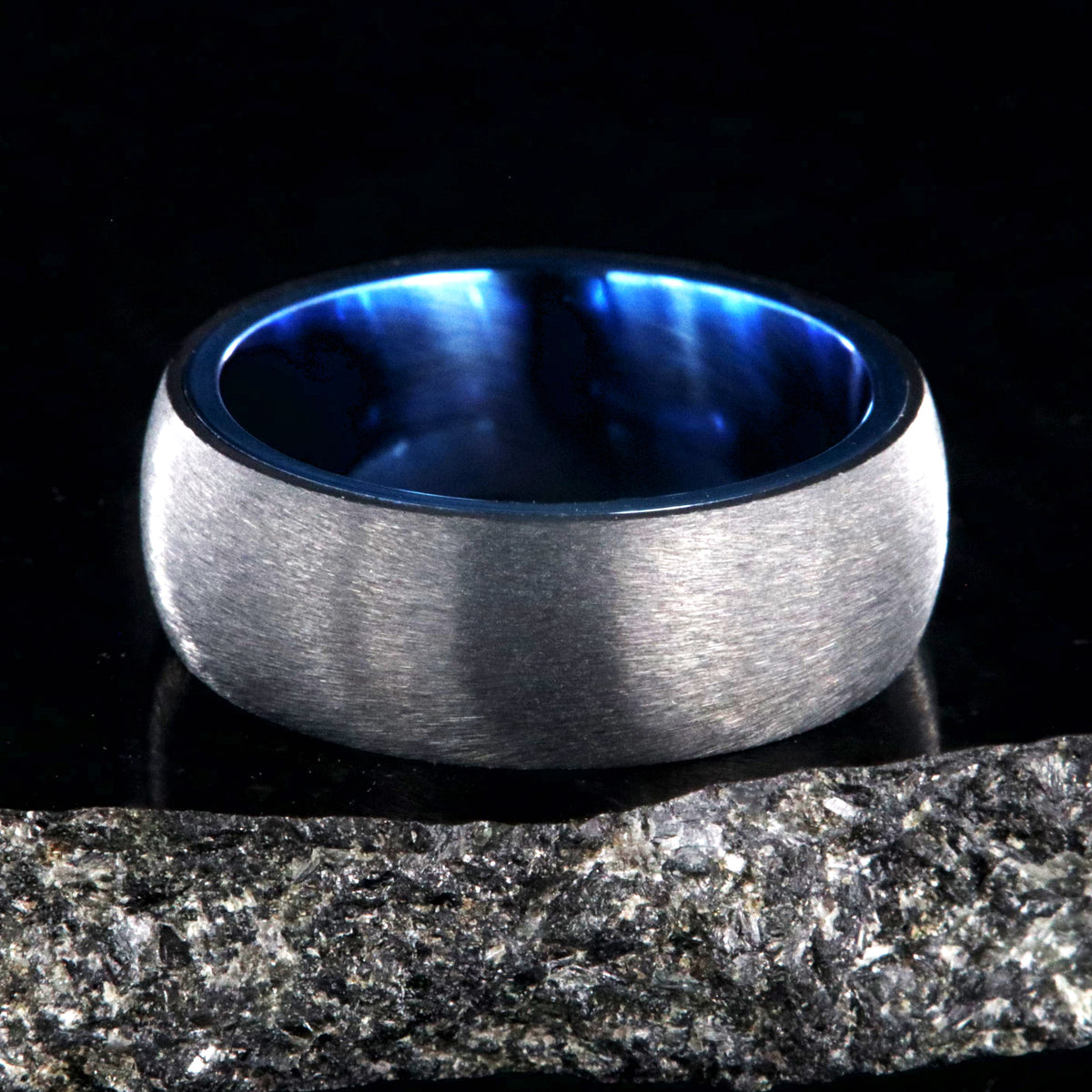 8mm wide titanium ring with a stone finish and blue sleeve