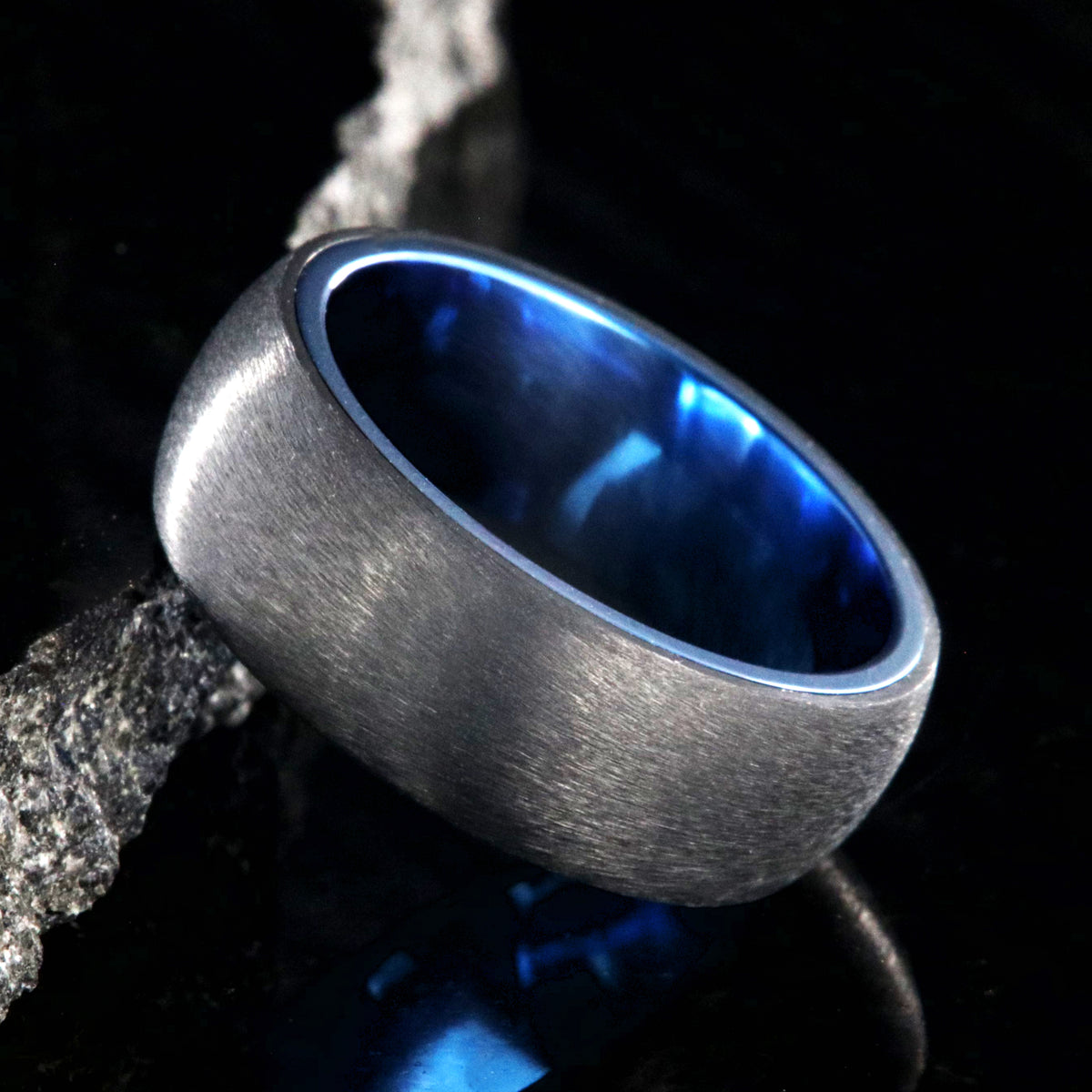 8mm wide titanium ring with a stone finish and blue sleeve
