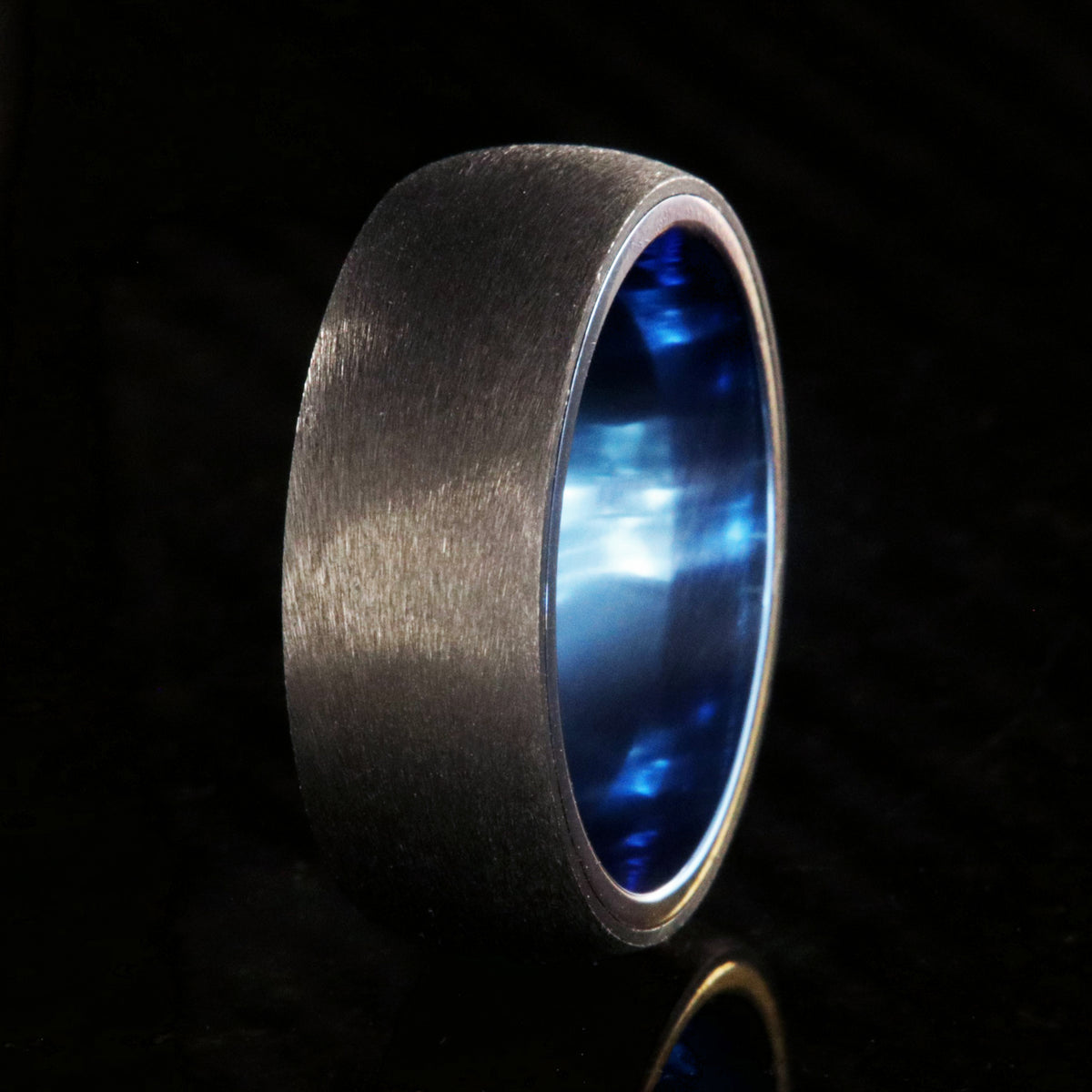 8mm wide titanium ring with a stone finish and blue sleeve
