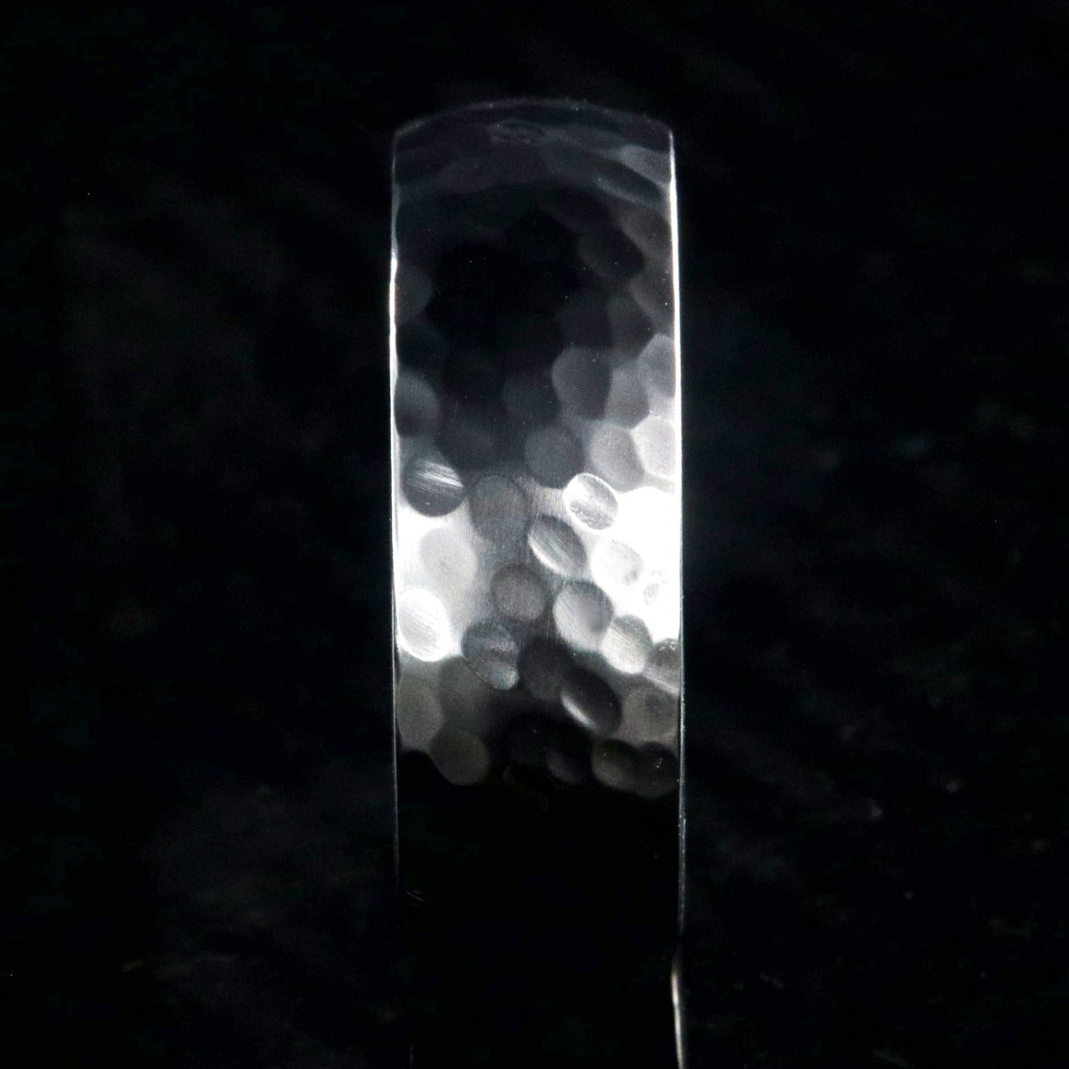 8mm wide black zirconium ring with a hammered finish and a rosewood sleeve