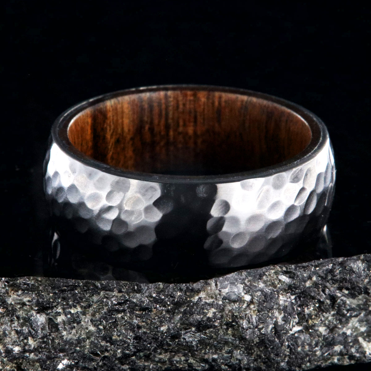 8mm wide black zirconium ring with a hammered finish and a rosewood sleeve
