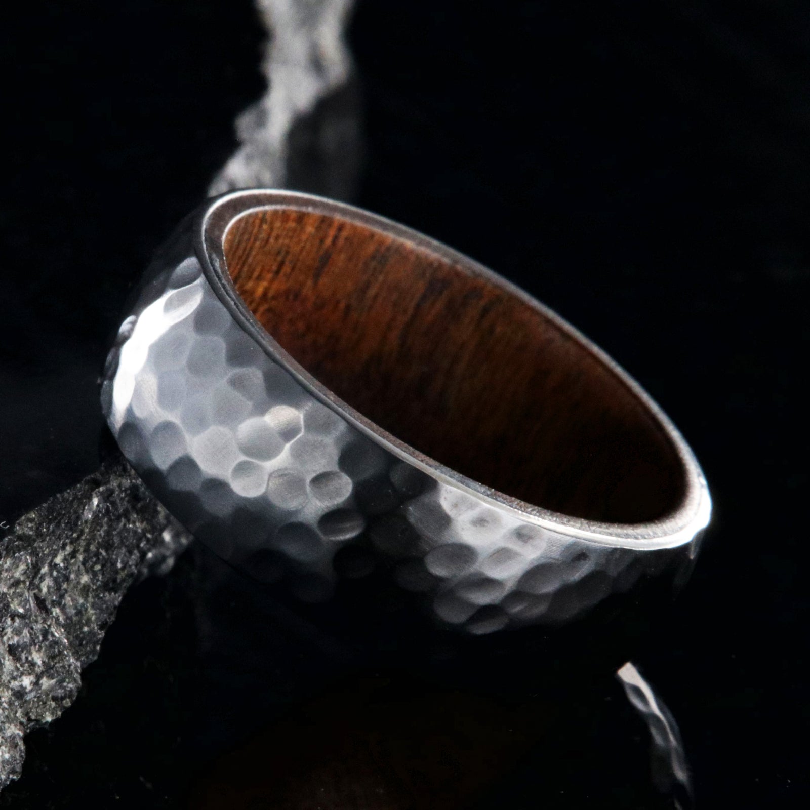 8mm wide black zirconium ring with a hammered finish and a rosewood sleeve