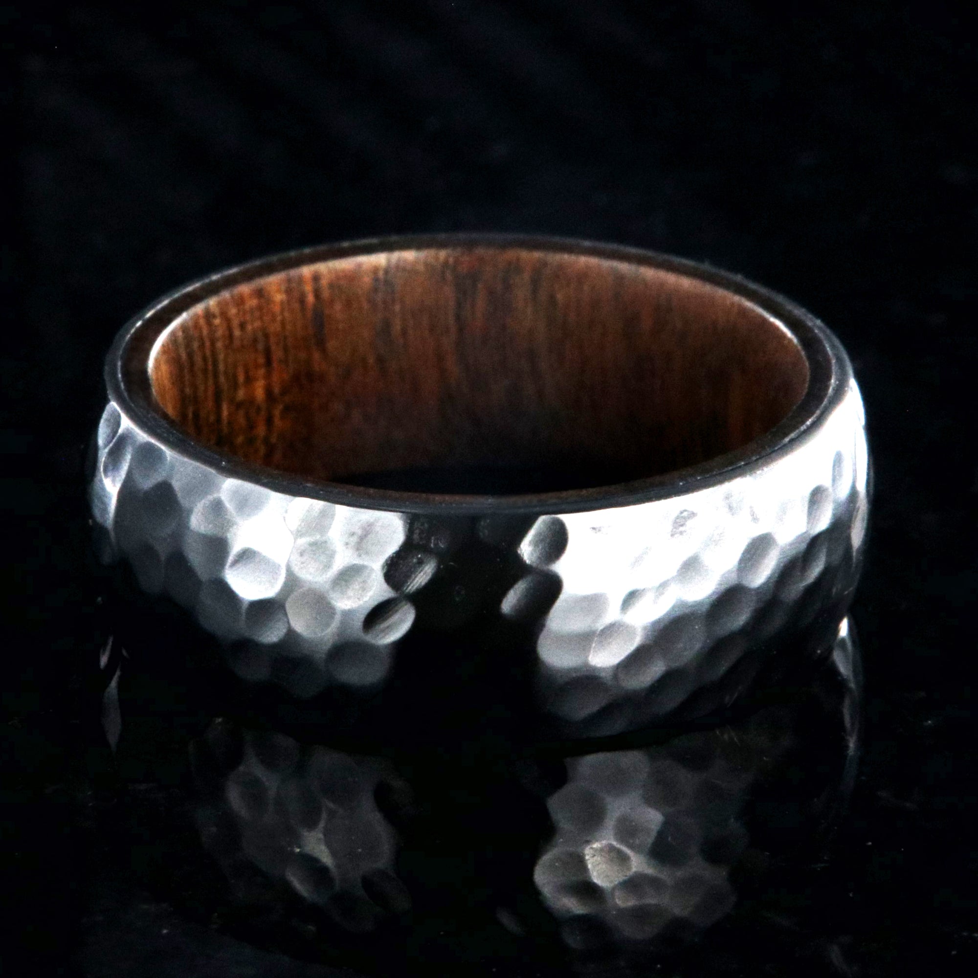 8mm wide black zirconium ring with a hammered finish and a rosewood sleeve