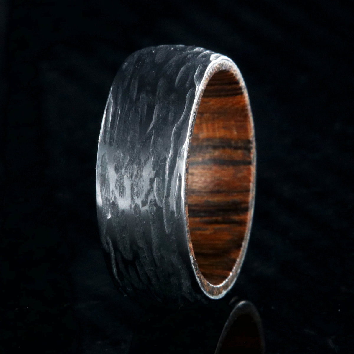 8mm wide black zirconium wedding band with a tree bark finish and bloodwood sleeve