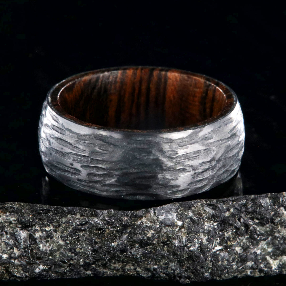 8mm wide black zirconium wedding band with a tree bark finish and bloodwood sleeve