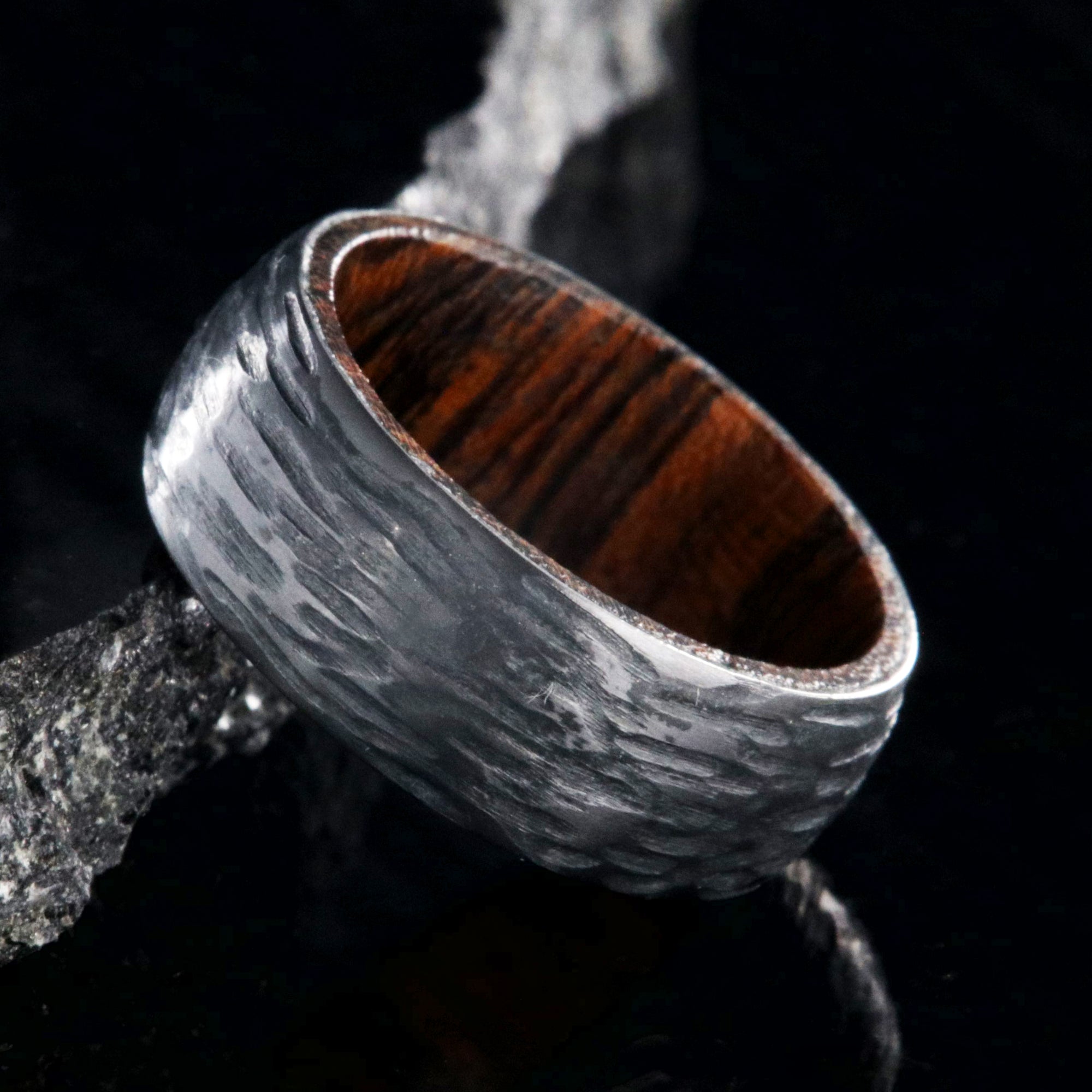 8mm wide black zirconium wedding band with a tree bark finish and bloodwood sleeve