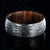 8mm wide black zirconium wedding band with a tree bark finish and bloodwood sleeve