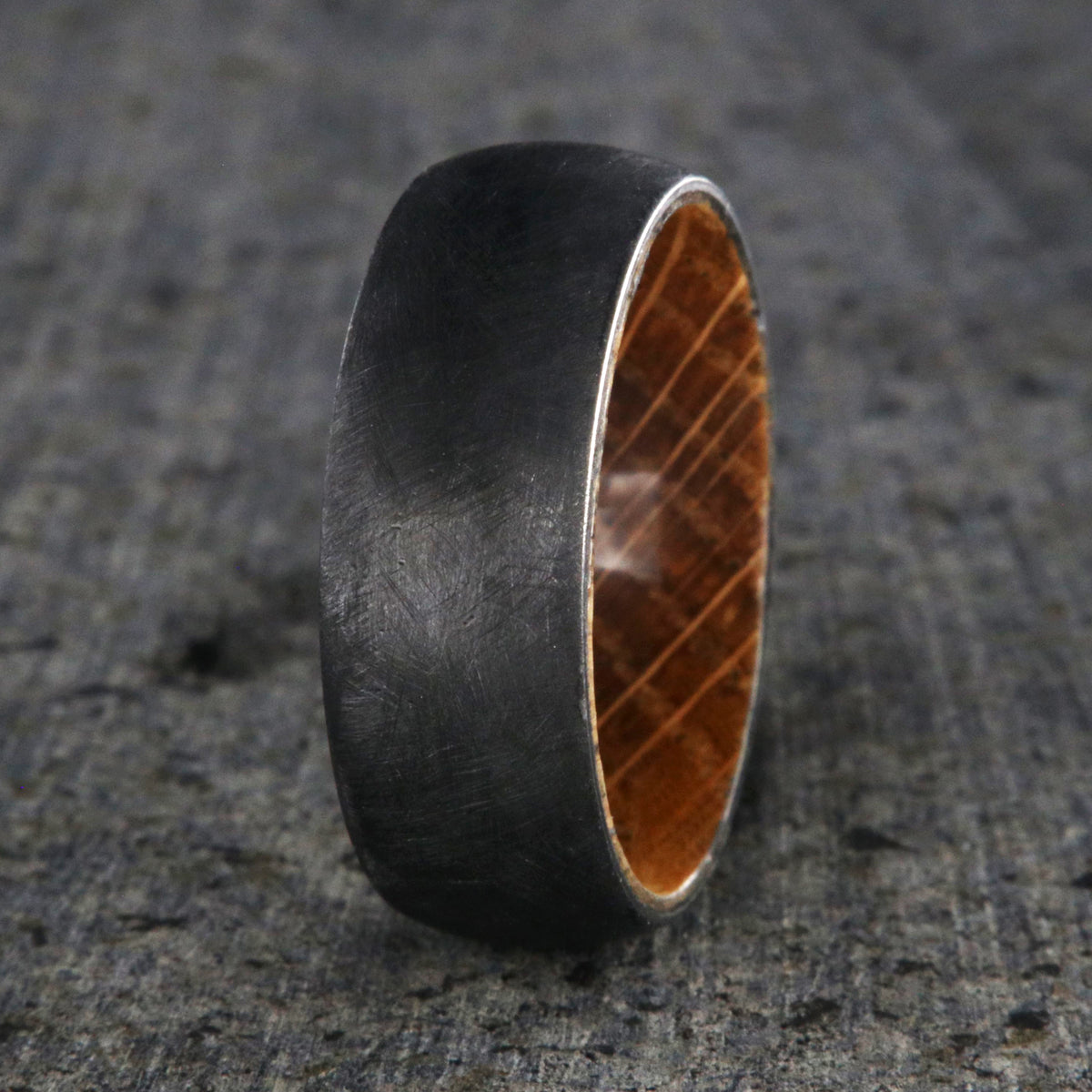 8mm wide black zirconium brushed finish wedding band with a whiskey barrel sleeve