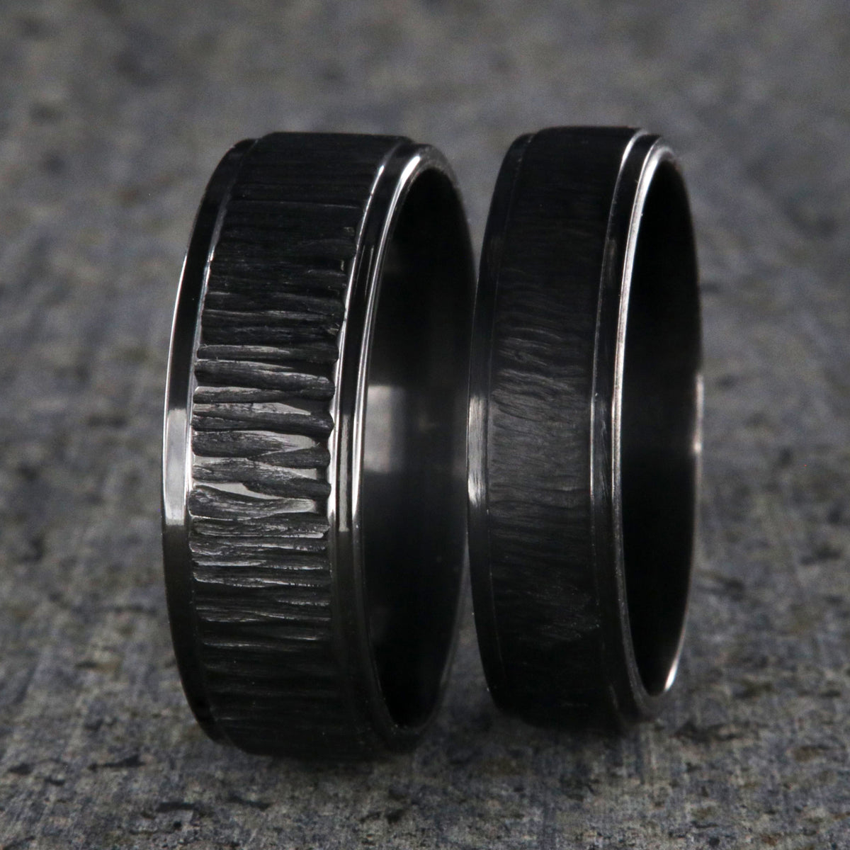 8mm and 6mm wide matching black zirconium wedding ring set with a raised center and tree bark finish
