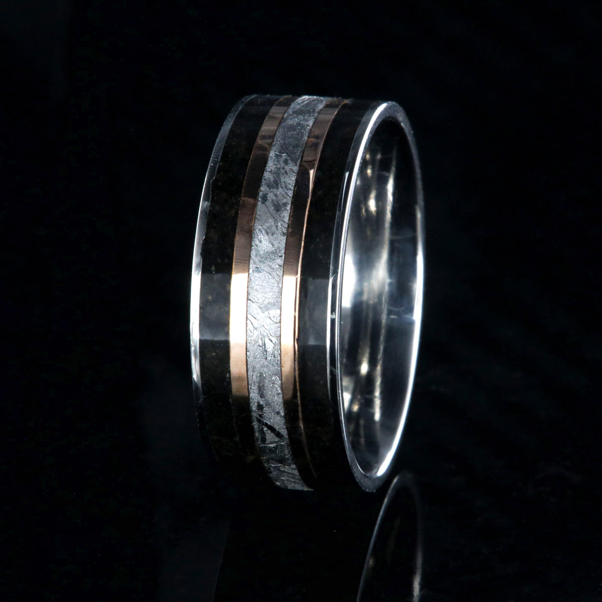 9mm wide ring with meteorite center, dual rose gold inlays, and dinosaur bone edges