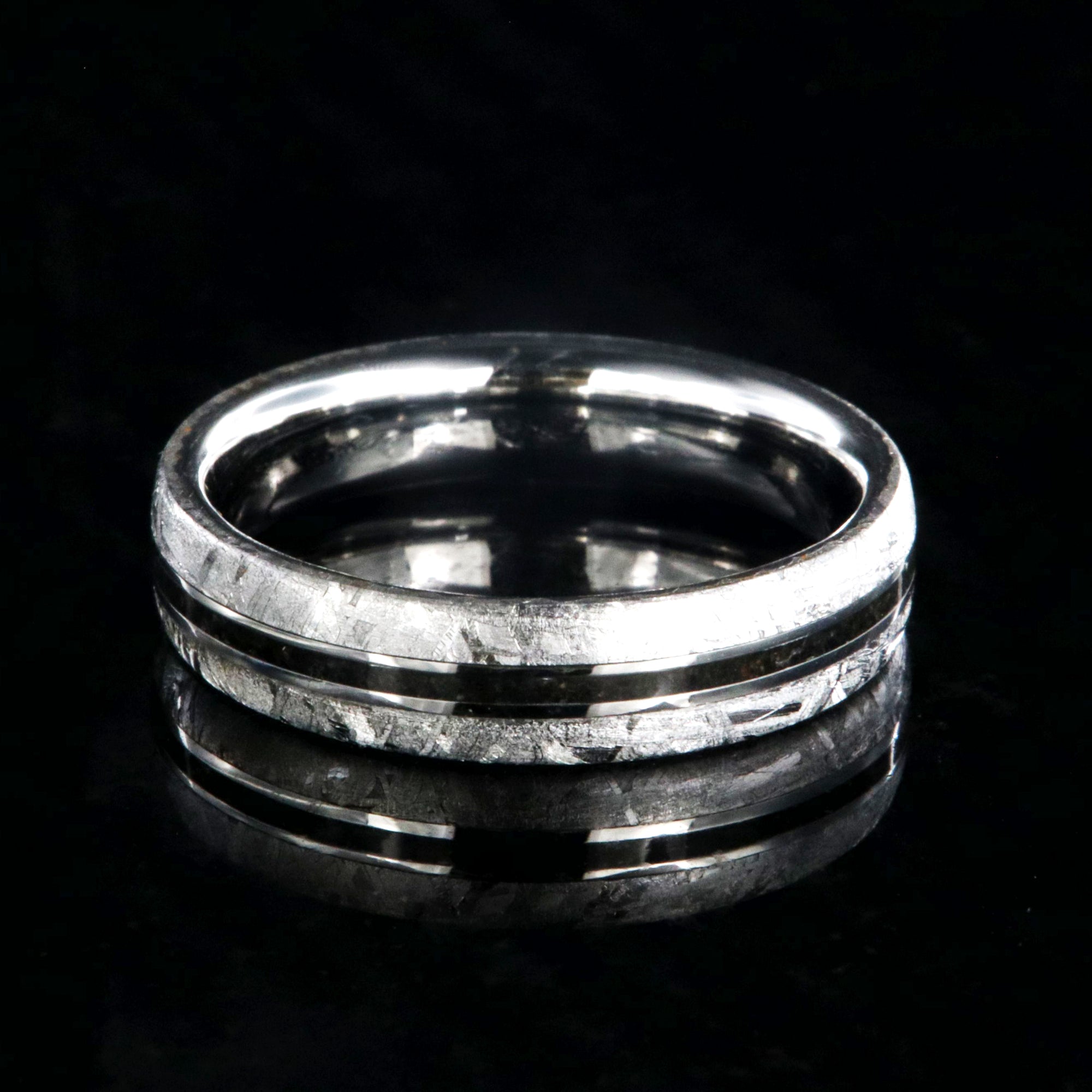 5mm wide women's wedding band with Gibeon meteorite edges and thin dinosaur bone inlay with cobalt sleeve
