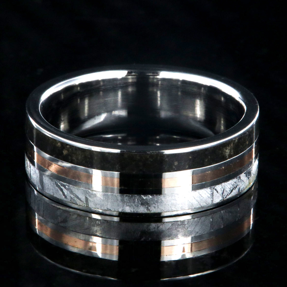 7mm wide wedding band with a center rose gold inlay and dinosaur fossil edge and meteorite edge