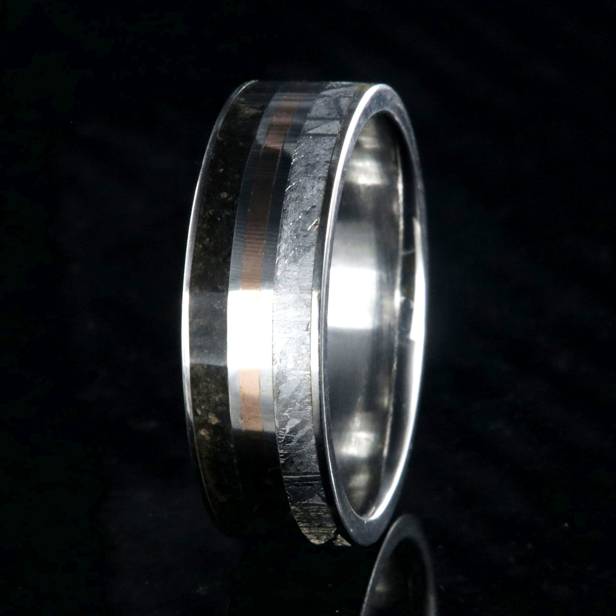 7mm wide wedding band with a center rose gold inlay and dinosaur fossil edge and meteorite edge